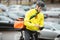 Male Cyclist With Courier Bag Using Mobile Phone
