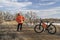 male cyclist with a mountain bike on a dirt trail, winter biking in Colorado