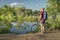 Male cyclist with a mountain bike on a lake shore