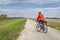 male cyclist is riding a gravel touring bike - biking on a levee trail along Chain of Rocks Canal