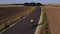 Male cyclist training on bicycle on countryside road