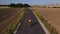 Male cyclist training on bicycle on countryside road