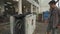 A male cyclist uses an automatic bicycle wash in the city. An automated cycle washing and cleaning machine in Germany.