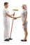 Male decorator with a roller painter shaking hands with a young woman