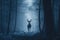 Male deer with antlers stand in blue dark misty forest.