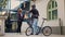 Male delivery employee giving woman paper bag with fastfood order