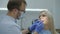 Male dentist conducts dental examination of young patient in dental office. Slow motion