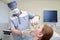 Male dentist examinating female patient at the clinic, Medical treatment at the dentist office.