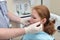 Male dentist examinating female patient at the clinic, Medical treatment at the dentist office.