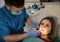 Male dentist examining a woman\'s teeth