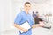 Male dentist surgeon holding dentures at his workplace