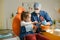 a male dentist teaches a little girl how to brush her teeth properly with a toothbrush.