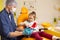 a male dentist teaches a little girl how to brush her teeth properly with a toothbrush.