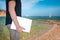 Male digital nomad hand holding laptop on the beach