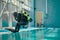 Male diver in scuba gear jumps into the pool