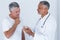 Male doctor advising senior man on medical prescriptions