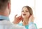 Male doctor checks little girl lymph nodes