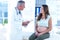 Male doctor in conversation with pregnant woman in hospital