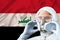 Male doctor, disinfector in a protective suit, respirator, glasses on the background of the Iraqi national flag of Iraq, the