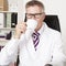 Male doctor drinking a cup of tea or coffee