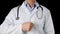 Male doctor hand showing thumbs up on medical gown and stethoscope background. Close up doctor showing thumbs up front