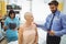 Male doctor interacting with a patient while nurse looking at x-ray