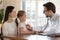 Male doctor listen to child patient heartbeat at meeting