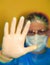 Male doctor in mask and glasses showing Stop Sign. Focus on Hand.  Medicine COVID-19 Stop Virus Concept. Healthcare and medicine.