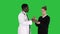 Male doctor offers medication to young woman on a Green Screen, Chroma Key.