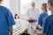 Male doctor with patient and female intern at the hospital