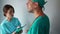 Male doctor prescribes a treatment regimen for a patient. A nurse writes his appointment on a medical record