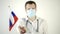 Male doctor in a protective mask waving the flag of Russia on a white background. Country coronavirus epidemic concept