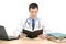 A male doctor reading a book in his office