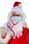 Male doctor, santa claus with a white beard, medical stethoscope, concept of christmas, waiting for gifts, preventive examination