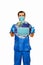 Male doctor in scrubs with face mask and gloves holding planet earth with protective face mask