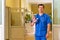 Male doctor in scrubs in hospital corridor, showing stop with palm. for coronavirus