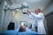 Male doctor sets up the machine to x-ray over patient