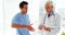 Male doctor shaking hands with coworker