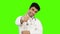 Male doctor showing thumbs up on green background