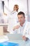 Male doctor sitting at desk doing paperwork