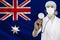 Male doctor with stethoscope on the background of the silk national flag of Australia, concept of national medical care, health,