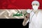 Male doctor with a stethoscope on the background of the silk national flag of Iraq, the concept of national medical care, health,