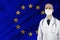 Male doctor with stethoscope on EU silk national flag background, concept of national medical care, health, insurance and tourism