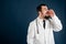 Male doctor with stethoscope in medical uniform shouting with her hand to his mouth