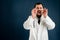 Male doctor with stethoscope in medical uniform shouting with her hands to his mouth