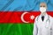 Male doctor in uniform on the background of the silk national flag of Azerbaijan, the concept of influenza, virus, COVID-19,