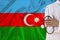 Male doctor in uniform on the background of the silk national flag of Azerbaijan, the concept of influenza, virus, COVID-19,