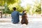 Male dog owner and his big dog relaxing in the park