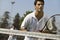 Male doubles tennis players waiting for serve front view focus on foreground