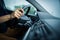 Male driver\'s hands driving a car on a highway